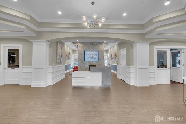 reception area featuring an inviting chandelier and ornate columns