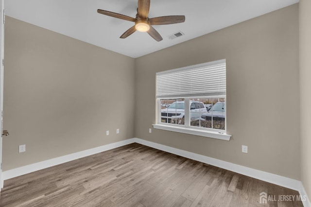 unfurnished room with ceiling fan and light wood-type flooring