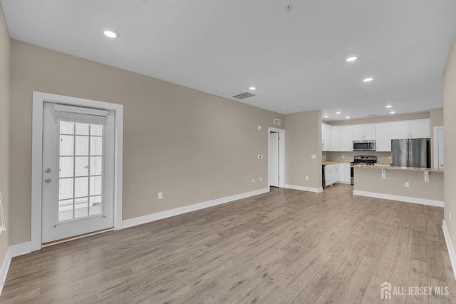 unfurnished living room with light wood-type flooring