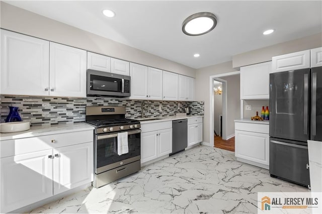 kitchen with white cabinetry, sink, and black appliances