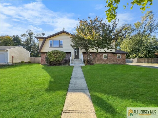 tri-level home featuring a front lawn