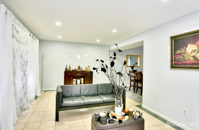 living room with light tile patterned floors and a chandelier