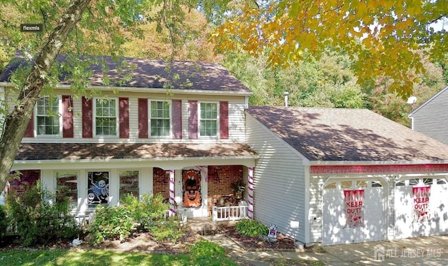 view of front of house with covered porch and a garage