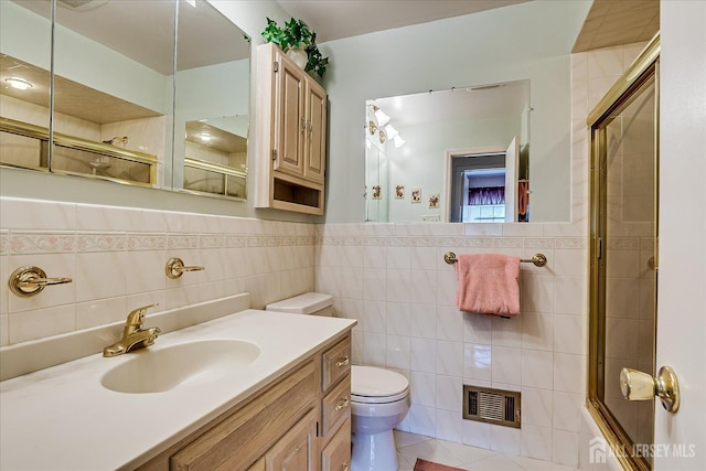 64 Annette Dr, Edison, NJ 08820 - full bath featuring tile walls, a shower with door, vanity, wainscoting, and tile patterned floors