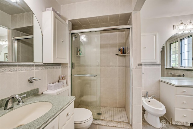 64 Annette Dr, Edison, NJ 08820 - bathroom with tile walls, a shower stall, a bidet, vanity, and tile patterned flooring