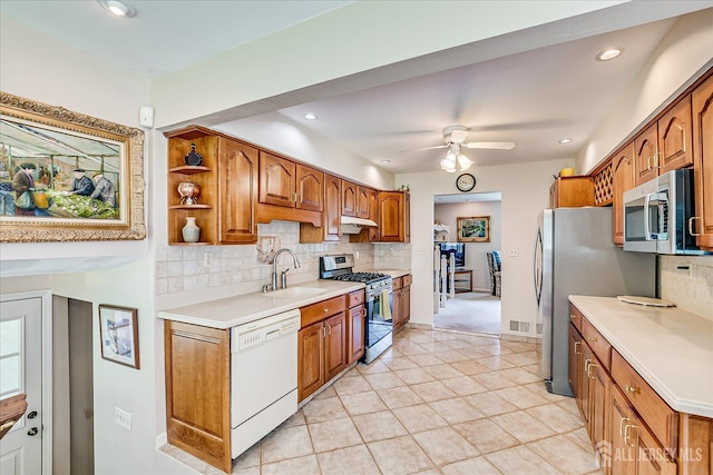 64 Annette Dr, Edison, NJ 08820 - kitchen featuring appliances with stainless steel finishes, backsplash, brown cabinetry, and recessed lighting