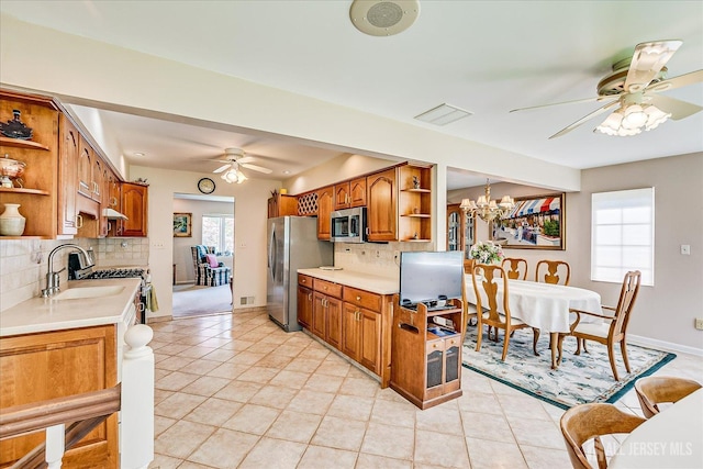 64 Annette Dr, Edison, NJ 08820 - kitchen featuring open shelves, ceiling fan, appliances with stainless steel finishes, decorative backsplash, and brown cabinetry