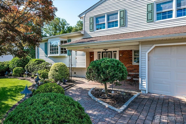 64 Annette Dr, Edison, NJ 08820 - property entrance with a garage, covered porch, and a lawn