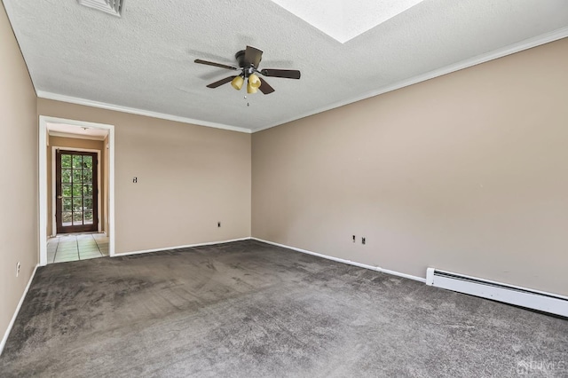 empty room featuring ceiling fan, a baseboard heating unit, a skylight, carpet, and a textured ceiling