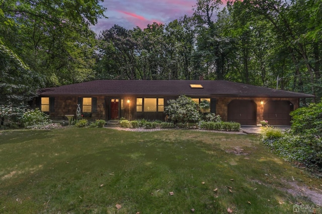 view of front of home featuring a garage and a lawn