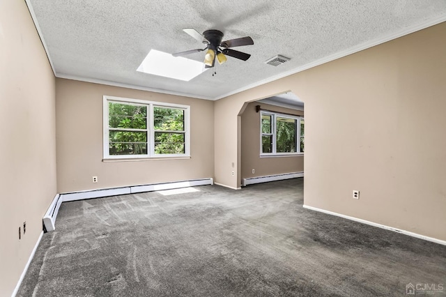 empty room with carpet floors, a skylight, a baseboard radiator, and ornamental molding