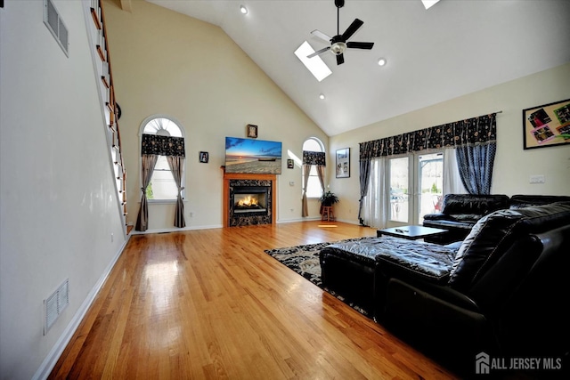 2 Eddie Ct, South Brunswick, NJ 08810 - living room with high vaulted ceiling, ceiling fan, a tile fireplace, wood finished floors, and baseboards