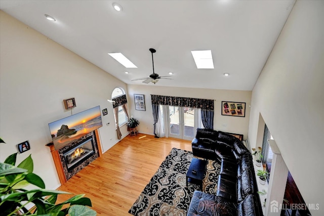2 Eddie Ct, South Brunswick, NJ 08810 - living room featuring a skylight, a glass covered fireplace, wood finished floors, ceiling fan, and recessed lighting