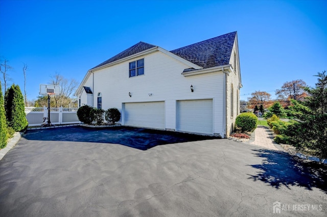 2 Eddie Ct, South Brunswick, NJ 08810 - view of home's exterior with asphalt driveway, an attached garage, and roof with shingles