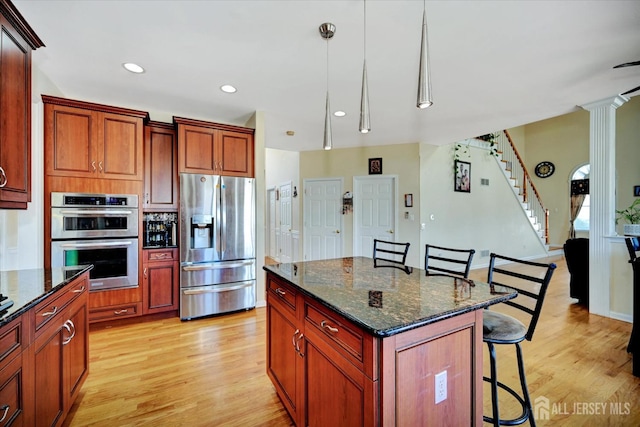 2 Eddie Ct, South Brunswick, NJ 08810 - kitchen featuring stainless steel appliances, a breakfast bar area, light wood-type flooring, decorative light fixtures, and recessed lighting
