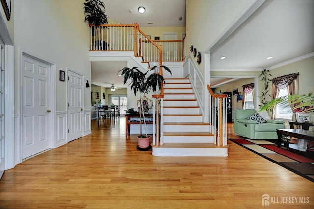 2 Eddie Ct, South Brunswick, NJ 08810 - entrance foyer featuring wood finished floors, stairway, crown molding, a high ceiling, and recessed lighting