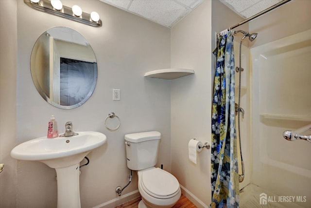 2 Eddie Ct, South Brunswick, NJ 08810 - full bath with curtained shower, toilet, baseboards, and a drop ceiling