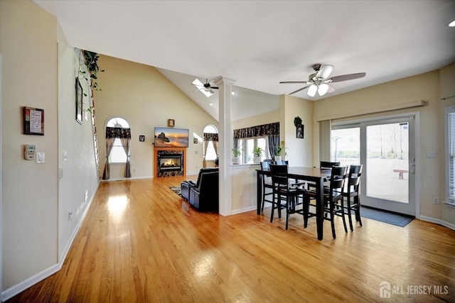 2 Eddie Ct, South Brunswick, NJ 08810 - dining space featuring ceiling fan, a glass covered fireplace, wood finished floors, vaulted ceiling, and baseboards