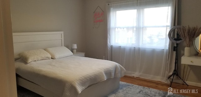 bedroom with wood finished floors