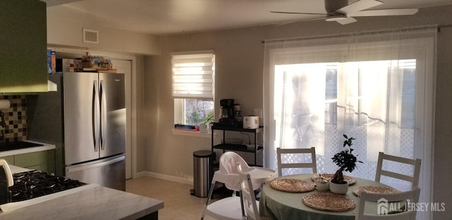 dining room featuring ceiling fan, visible vents, and baseboards