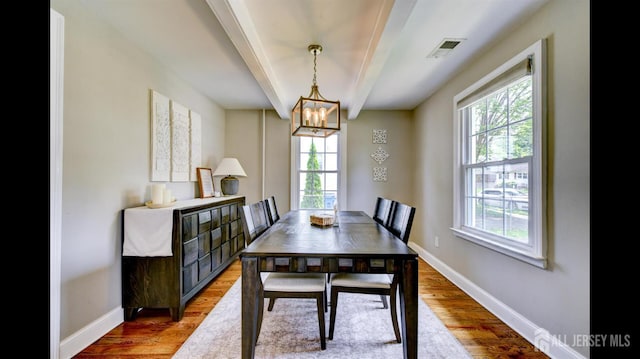 3 Mayfield Pl, Metuchen, NJ 08840 - dining area with healthy amount of natural light, beamed ceiling, a chandelier, and light wood-type flooring