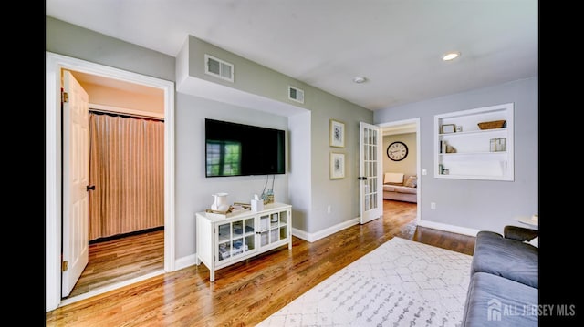 3 Mayfield Pl, Metuchen, NJ 08840 - living area with french doors, wood finished floors, built in shelves, and recessed lighting