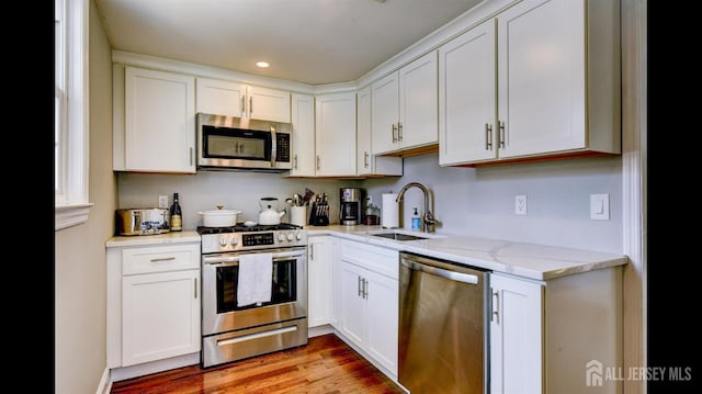 3 Mayfield Pl, Metuchen, NJ 08840 - kitchen with stainless steel appliances, white cabinetry, light stone counters, recessed lighting, and light wood-type flooring