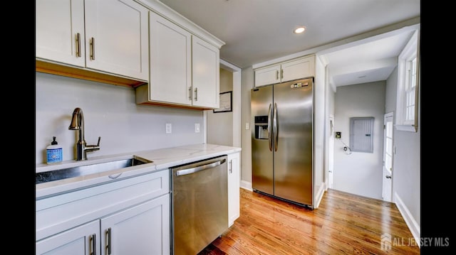 3 Mayfield Pl, Metuchen, NJ 08840 - kitchen featuring appliances with stainless steel finishes, light wood finished floors, white cabinetry, light stone counters, and recessed lighting