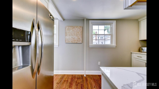 3 Mayfield Pl, Metuchen, NJ 08840 - kitchen with stainless steel fridge with ice dispenser, white cabinets, light stone counters, and wood finished floors