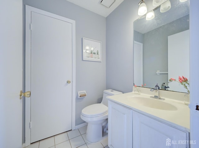 half bathroom featuring tile patterned flooring, visible vents, toilet, and vanity