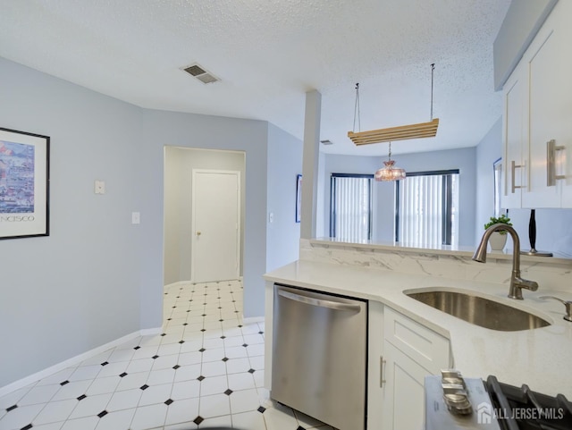 kitchen featuring visible vents, a sink, a textured ceiling, white cabinetry, and dishwasher