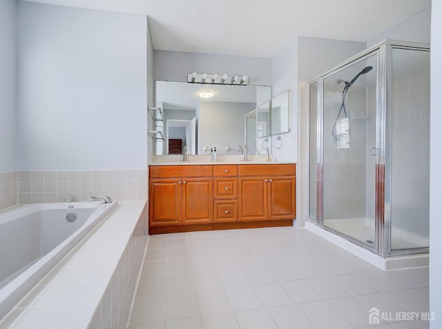 full bath with a garden tub, double vanity, a stall shower, and tile patterned floors