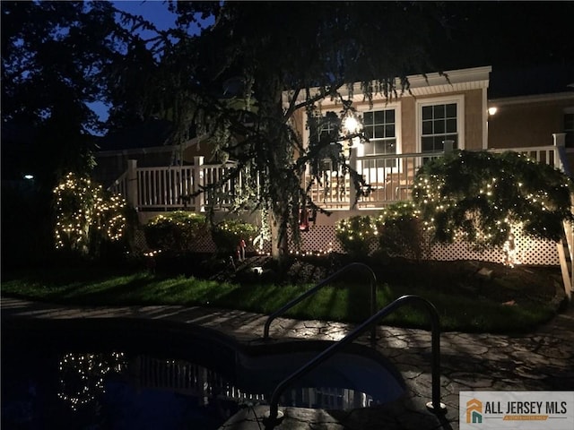 5 Serviss Ave, East Brunswick, NJ 08816 - property exterior at twilight featuring a swimming pool and stucco siding