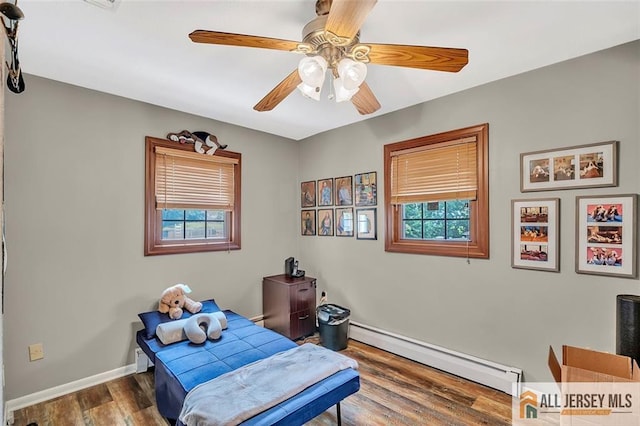 5 Serviss Ave, East Brunswick, NJ 08816 - bedroom featuring a baseboard radiator, multiple windows, wood finished floors, and a ceiling fan