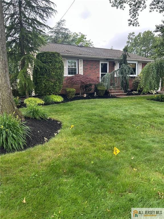 5 Serviss Ave, East Brunswick, NJ 08816 - view of front of home with brick siding and a front yard
