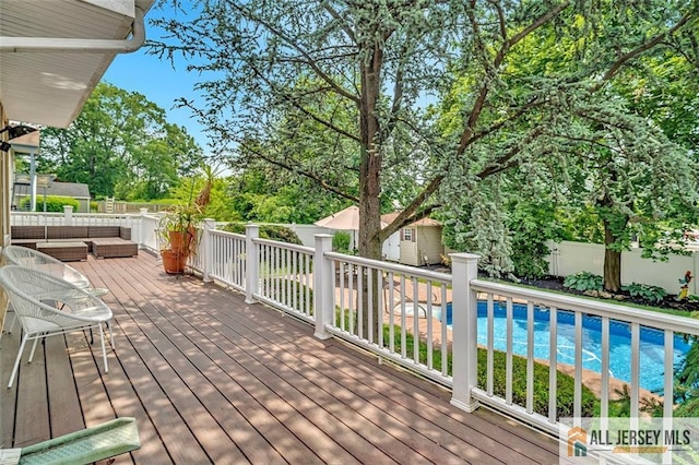 5 Serviss Ave, East Brunswick, NJ 08816 - wooden terrace featuring a fenced backyard, an outbuilding, an outdoor living space, and view of scattered trees