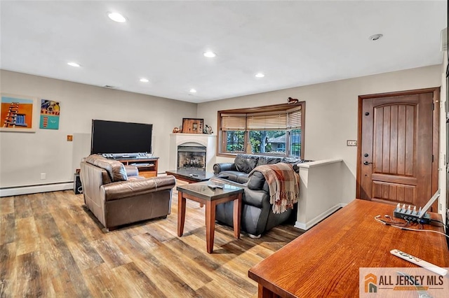5 Serviss Ave, East Brunswick, NJ 08816 - living area with a baseboard radiator, wood finished floors, recessed lighting, and a fireplace