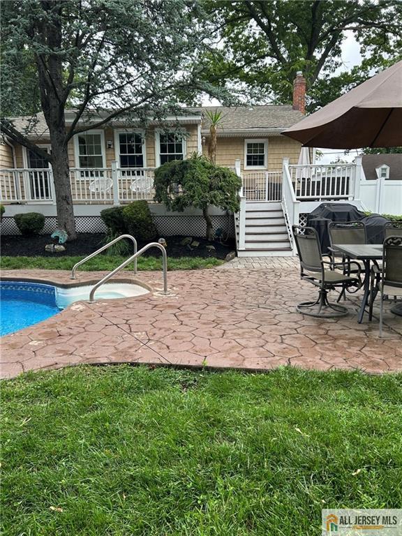 5 Serviss Ave, East Brunswick, NJ 08816 - rear view of house with an outdoor pool, a patio, a chimney, a deck, and stairway