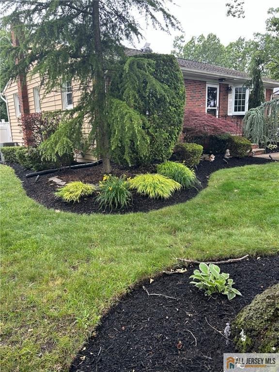 5 Serviss Ave, East Brunswick, NJ 08816 - view of property exterior featuring brick siding and a lawn