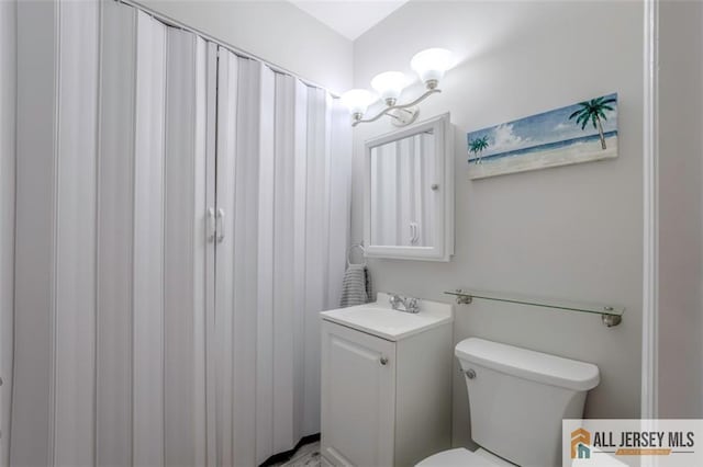 bathroom featuring vanity and toilet