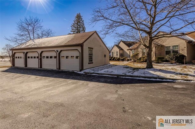 view of side of home featuring a garage