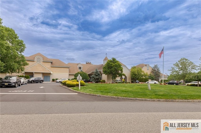 view of front of property with a residential view and a front lawn