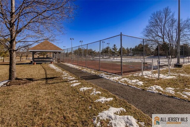 view of sport court featuring fence and a gazebo