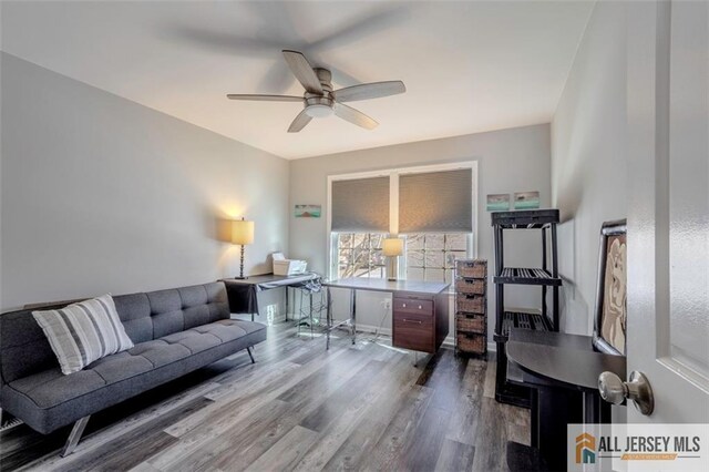 living area with ceiling fan and wood finished floors