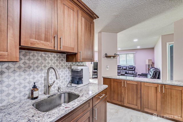 19 Carriage Pl, Edison, NJ 08820 - kitchen with light stone countertops, backsplash, brown cabinets, and a textured ceiling
