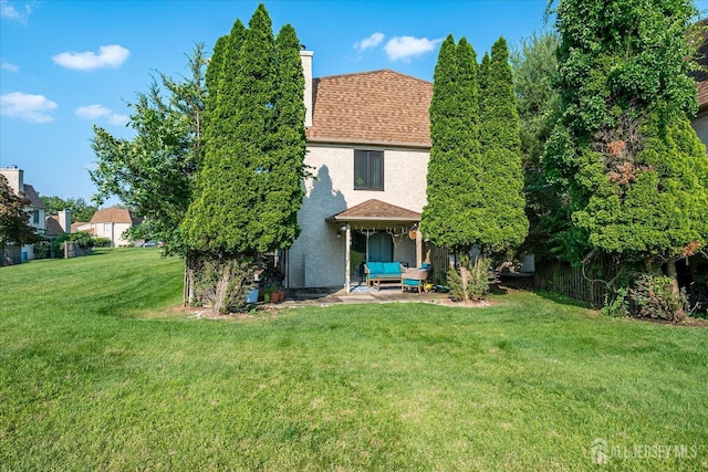 19 Carriage Pl, Edison, NJ 08820 - back of property featuring stucco siding, a chimney, a shingled roof, a patio area, and outdoor lounge area