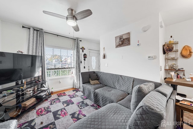 living room with ceiling fan and wood finished floors