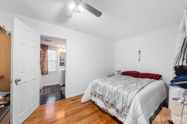 bedroom with ceiling fan, baseboards, and wood finished floors