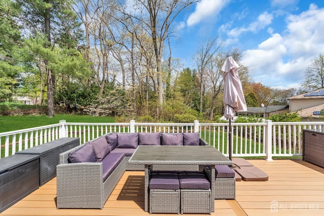 wooden terrace with outdoor dining area, a yard, and outdoor lounge area