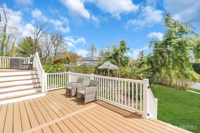 deck featuring a lawn, stairway, and a gazebo